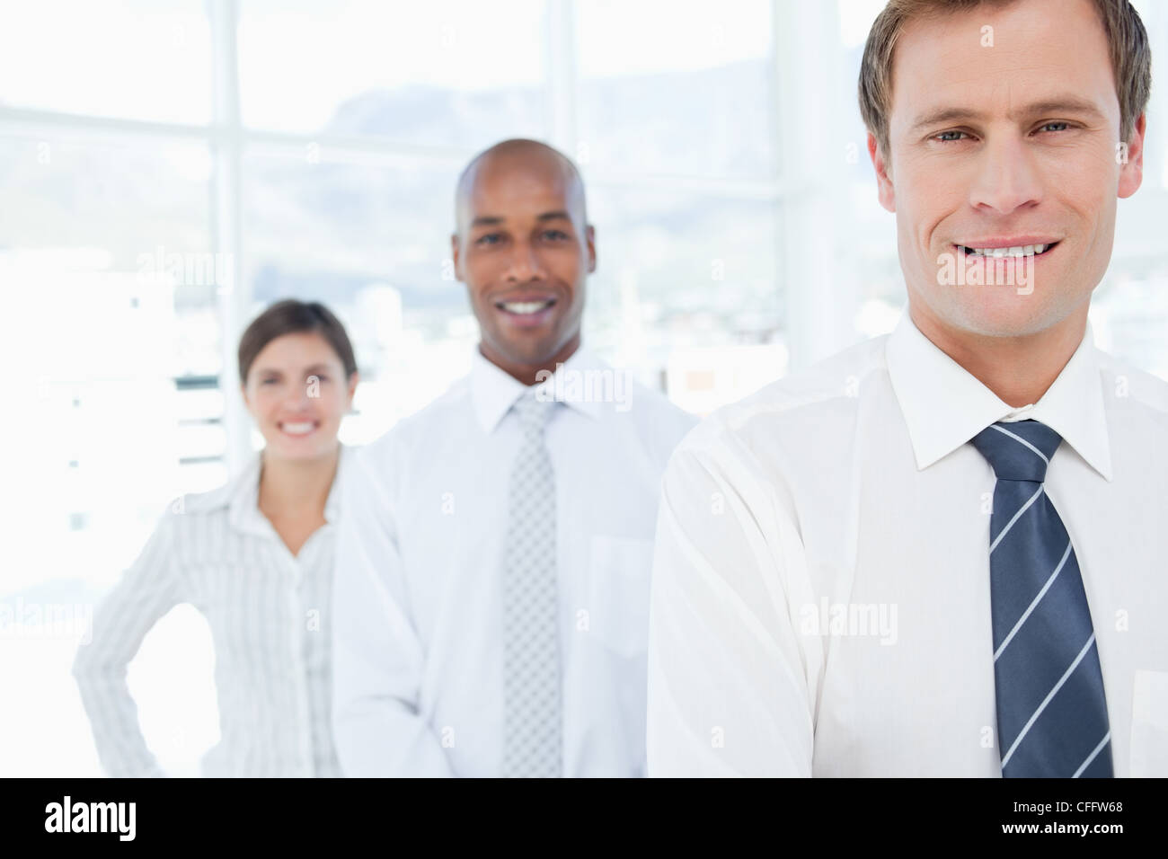 Smiling salesteam standing in a line Stock Photo