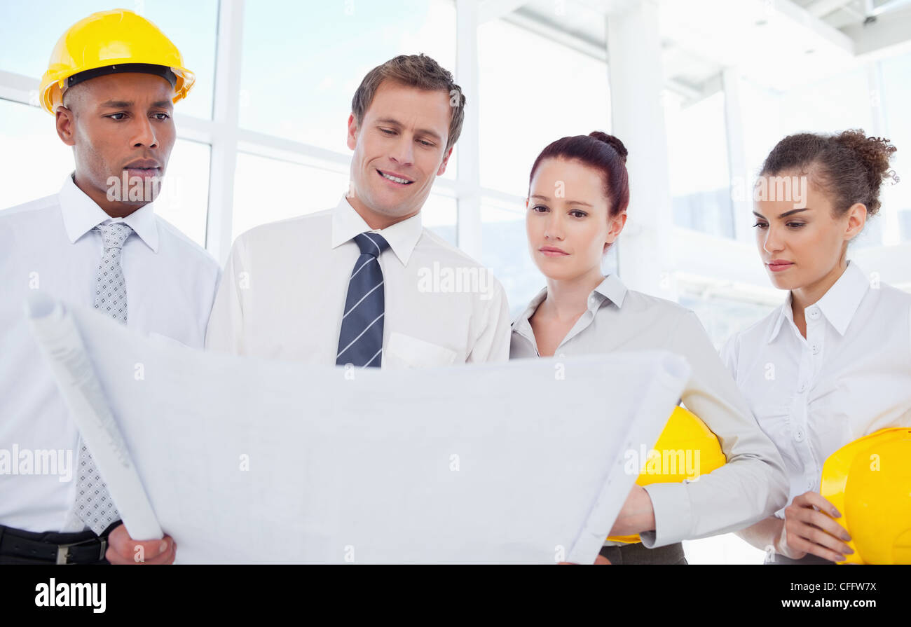 Team of architects looking at a blueprint Stock Photo