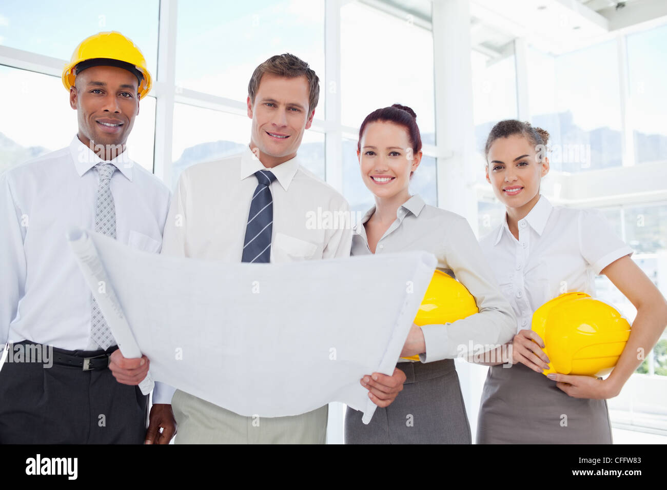 Smiling architects together with a blueprint Stock Photo
