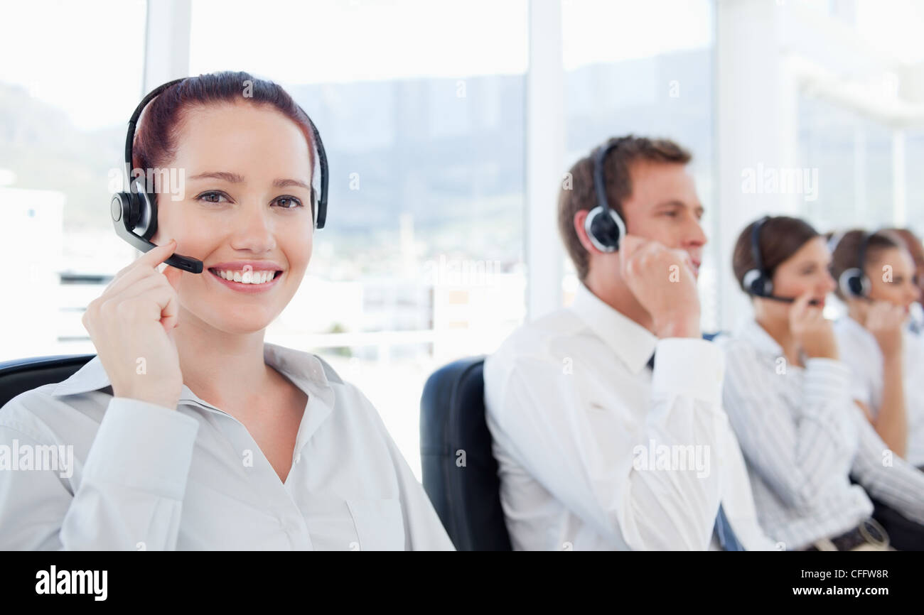 Smiling telephone help desk employee at work Stock Photo Alamy