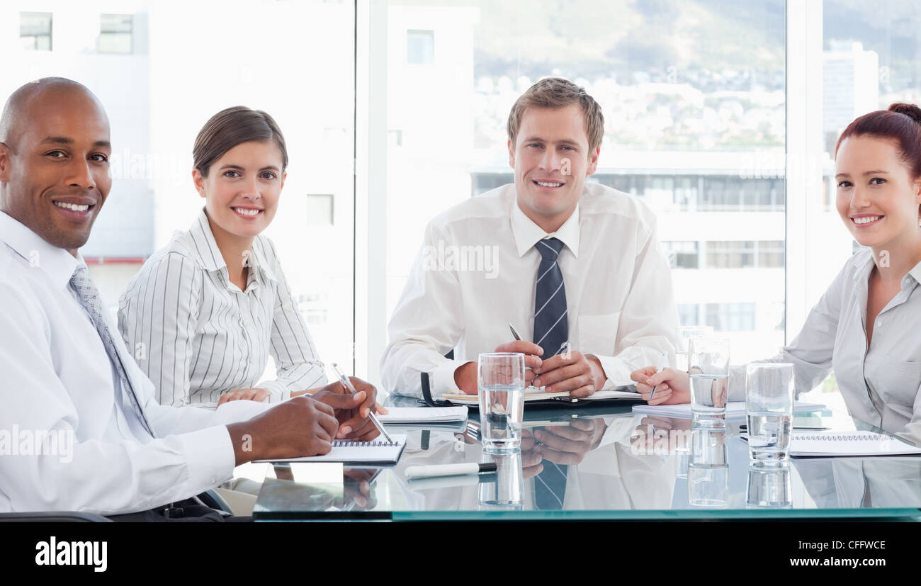 Smiling salespeople in a meeting Stock Photo