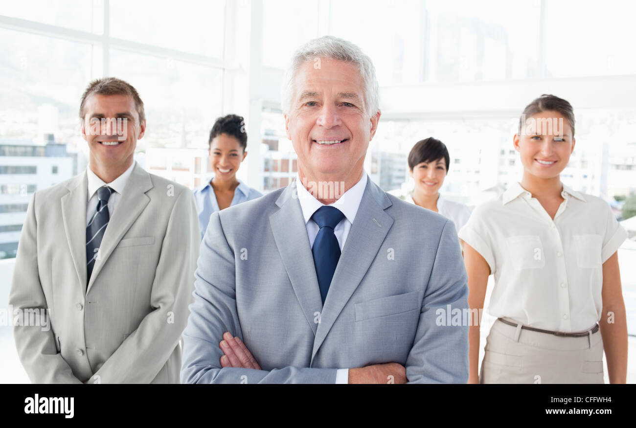 Manager with his team behind him Stock Photo - Alamy