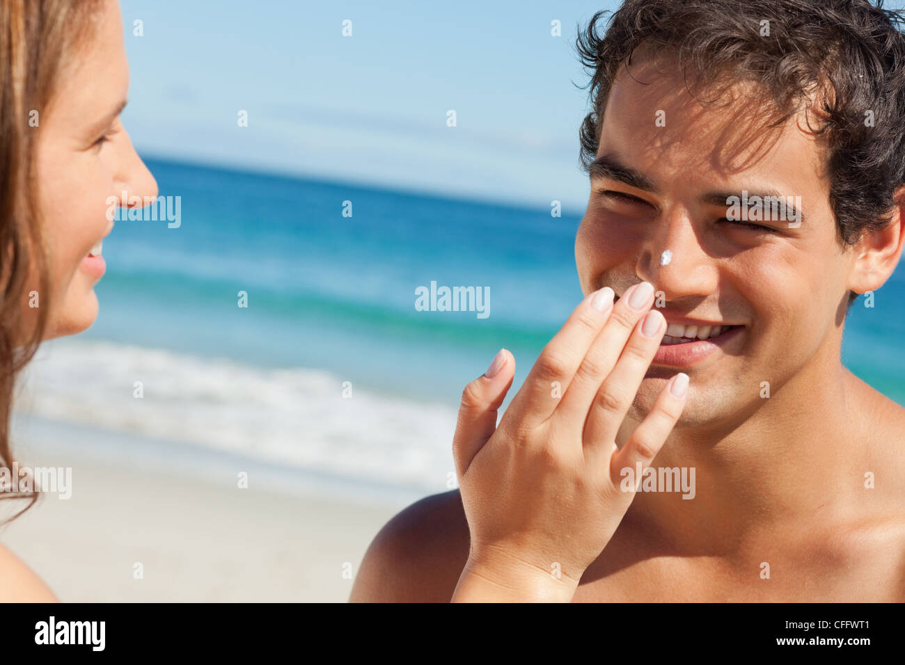 Woman putting some sunscreen on her boyfriend's nose Stock Photo Alamy