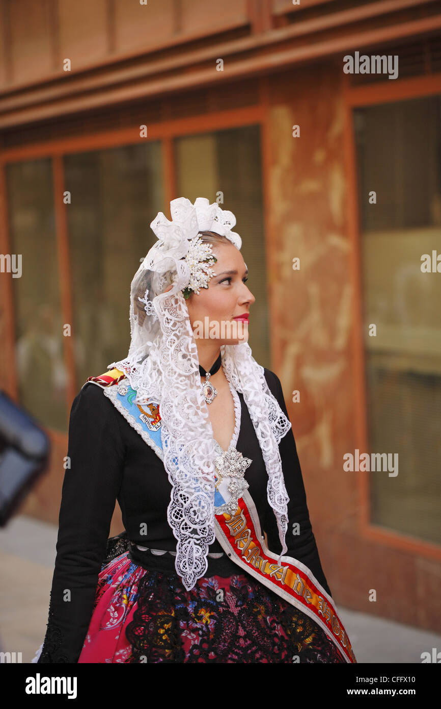 Spanish woman wearing traditional dress during the street procession ...