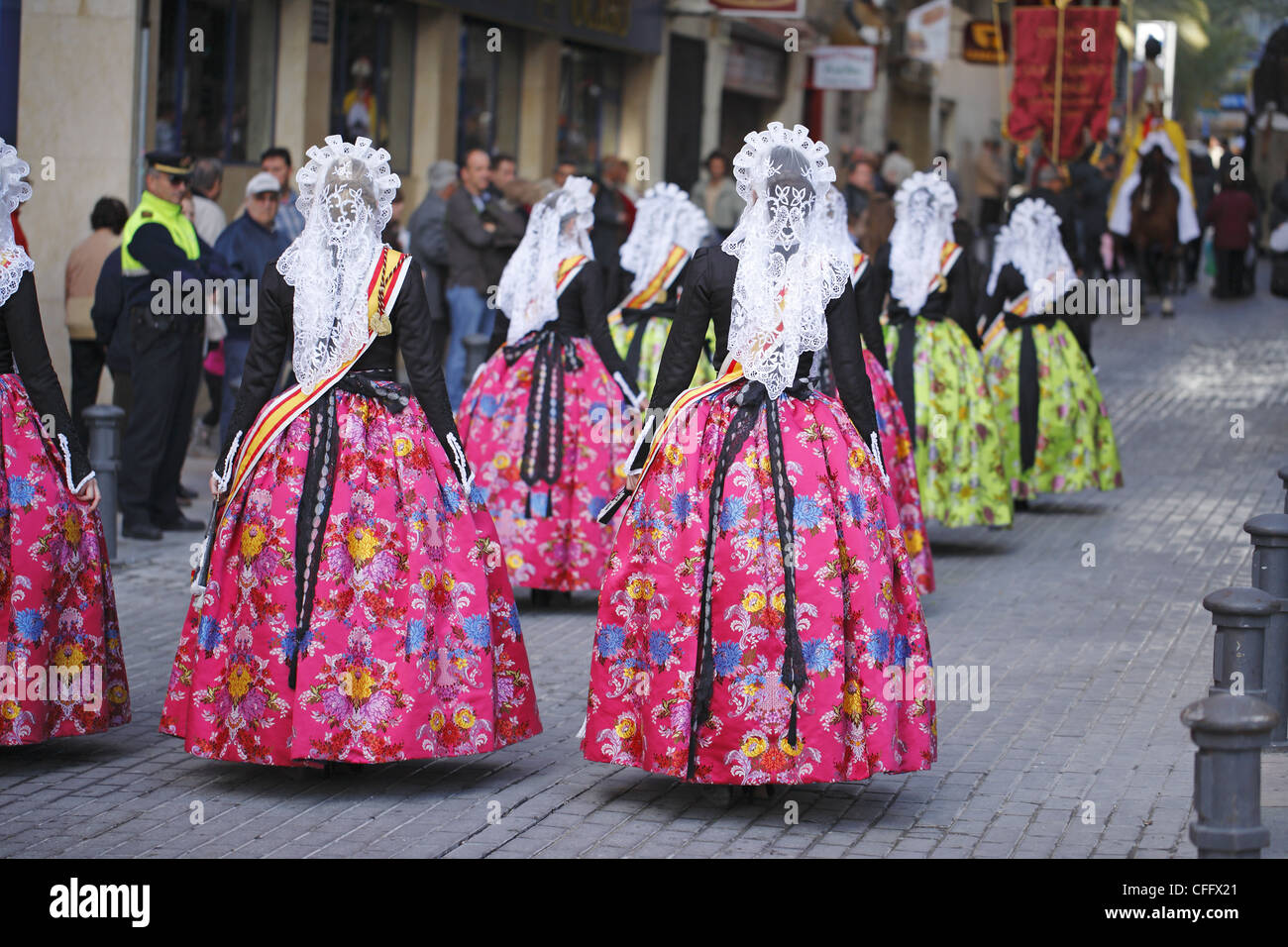 Spanish women wearing traditional clothes during the street procession ...