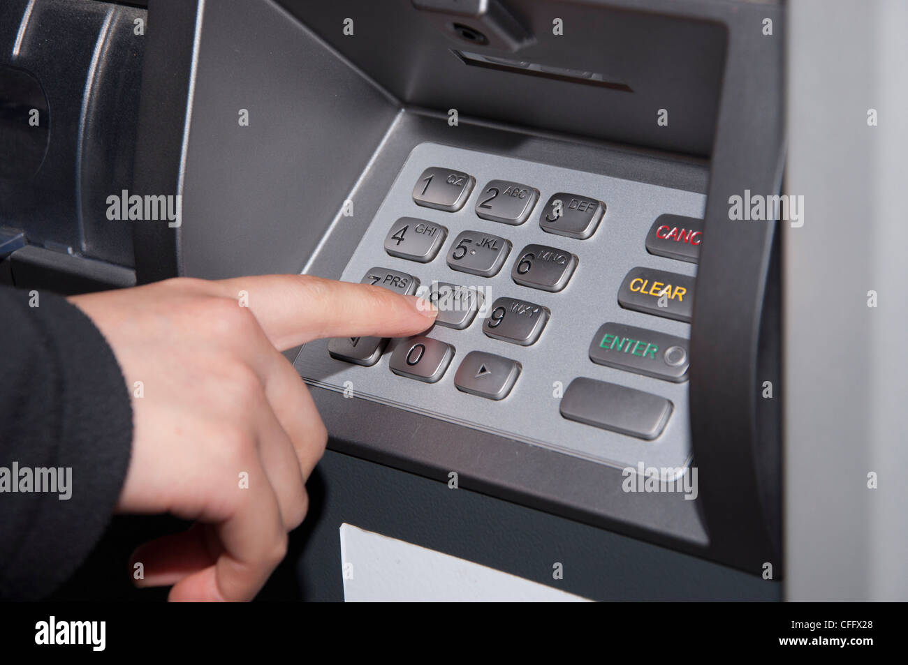 Someone pressing number button on ATM machine Stock Photo