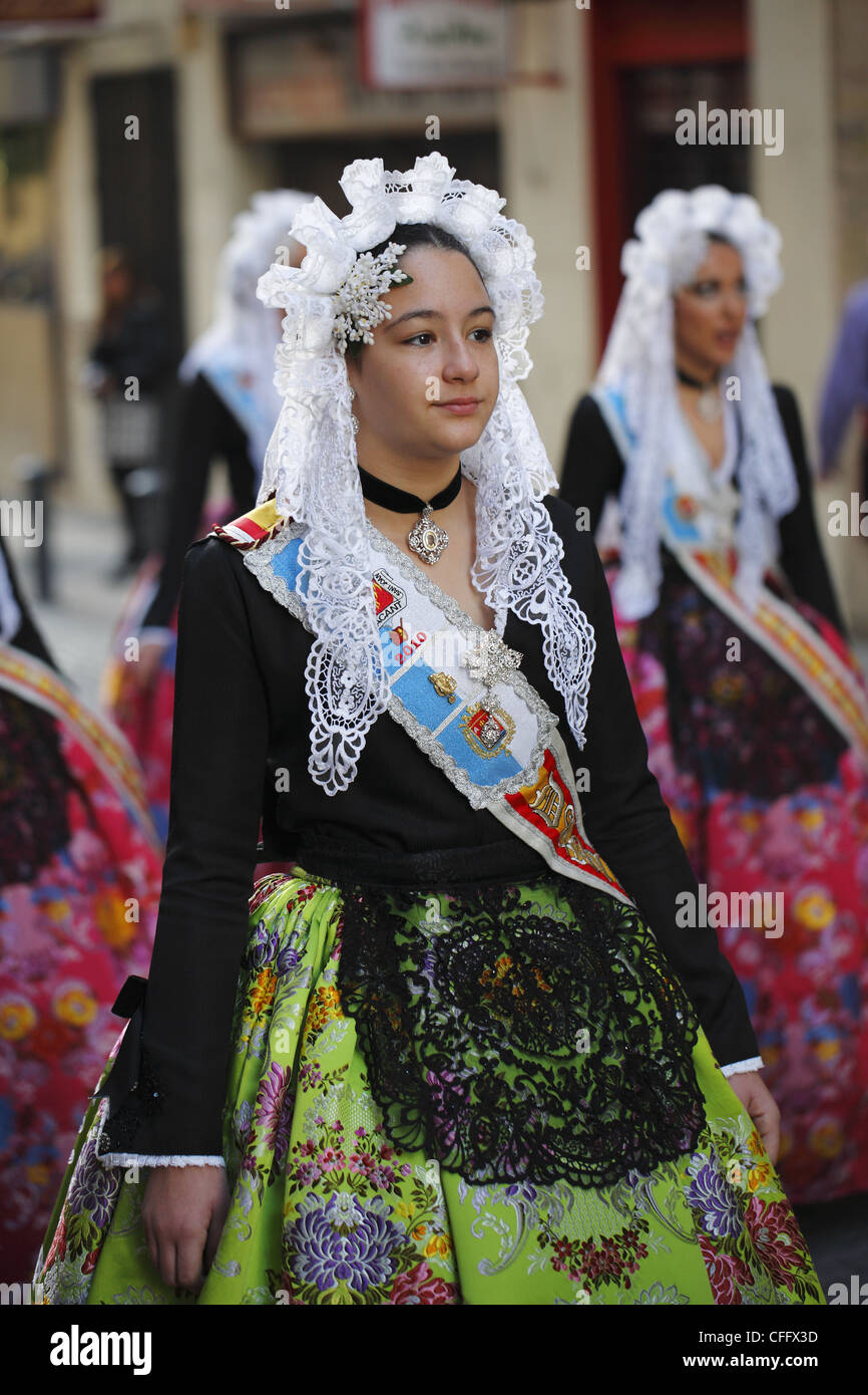 Spanish girls wearing traditional clothing during the street procession ...