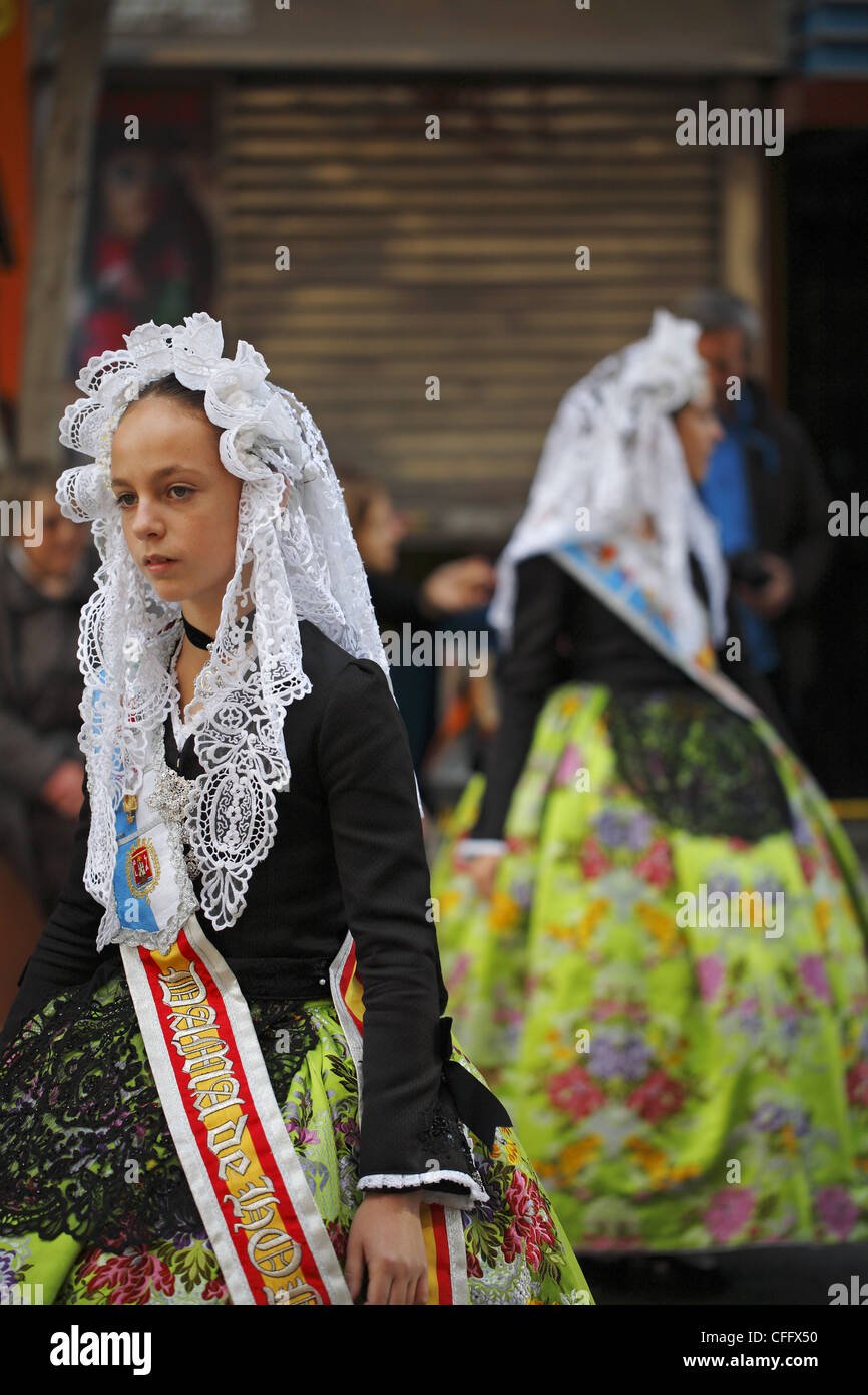 Spanish girls wearing traditional clothing during the street procession ...