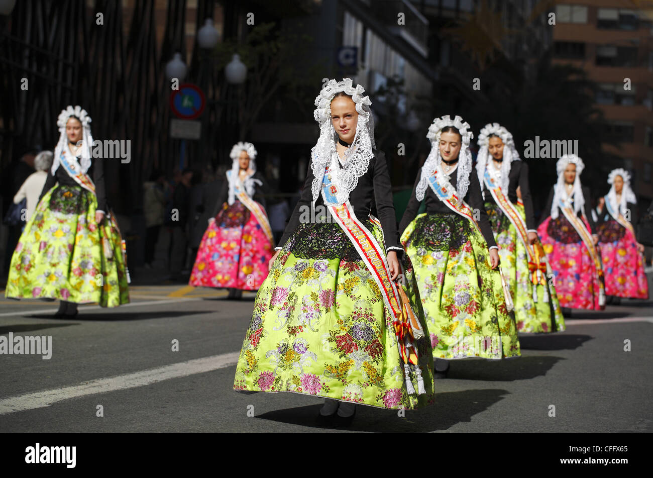Spanish girls wearing traditional clothing during the street procession ...