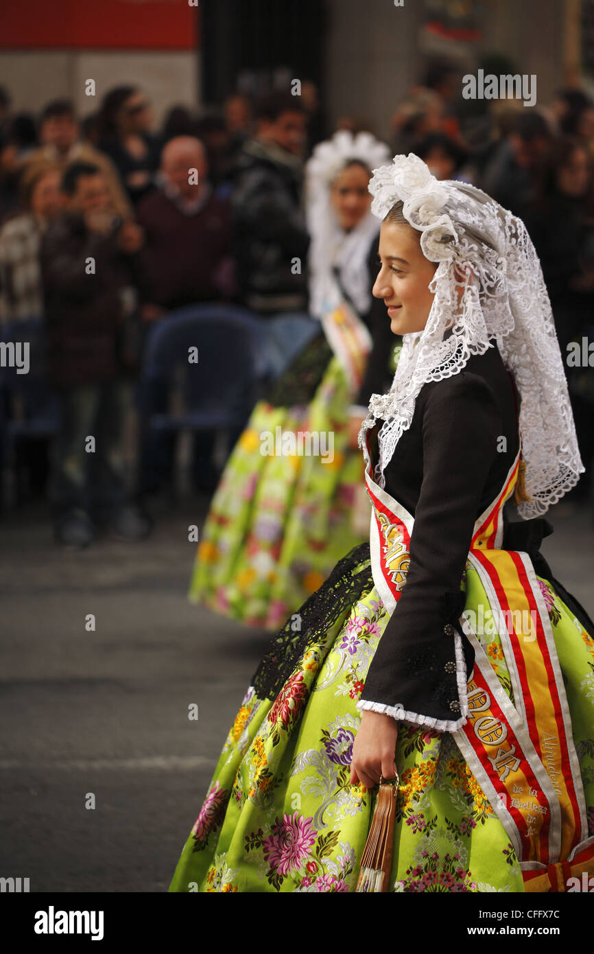 Spanish girls wearing traditional clothing during the street procession ...