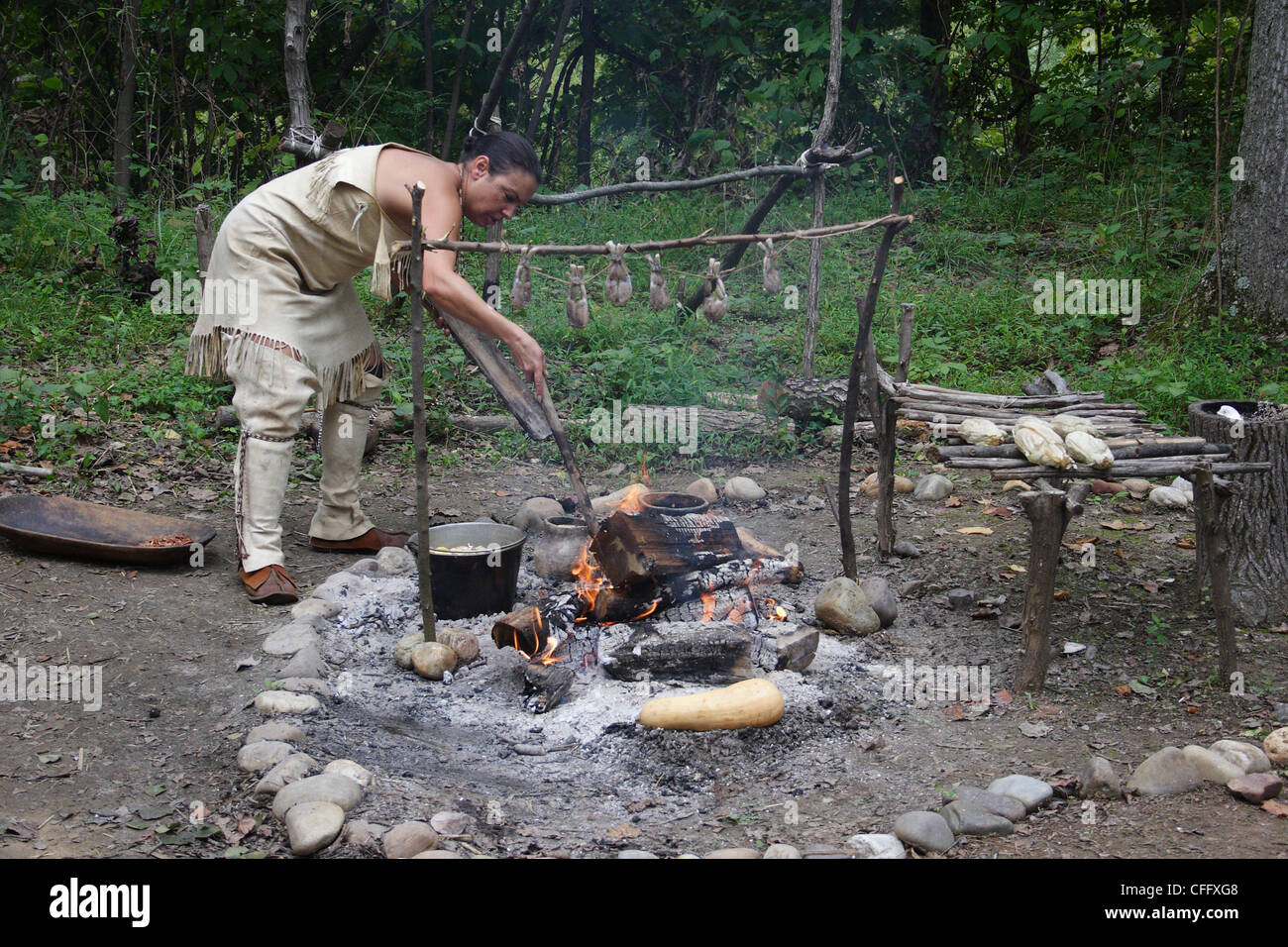 Native American woman cooking 17th century meal during Publick Days event at Henricus historical site in Virginia. Stock Photo