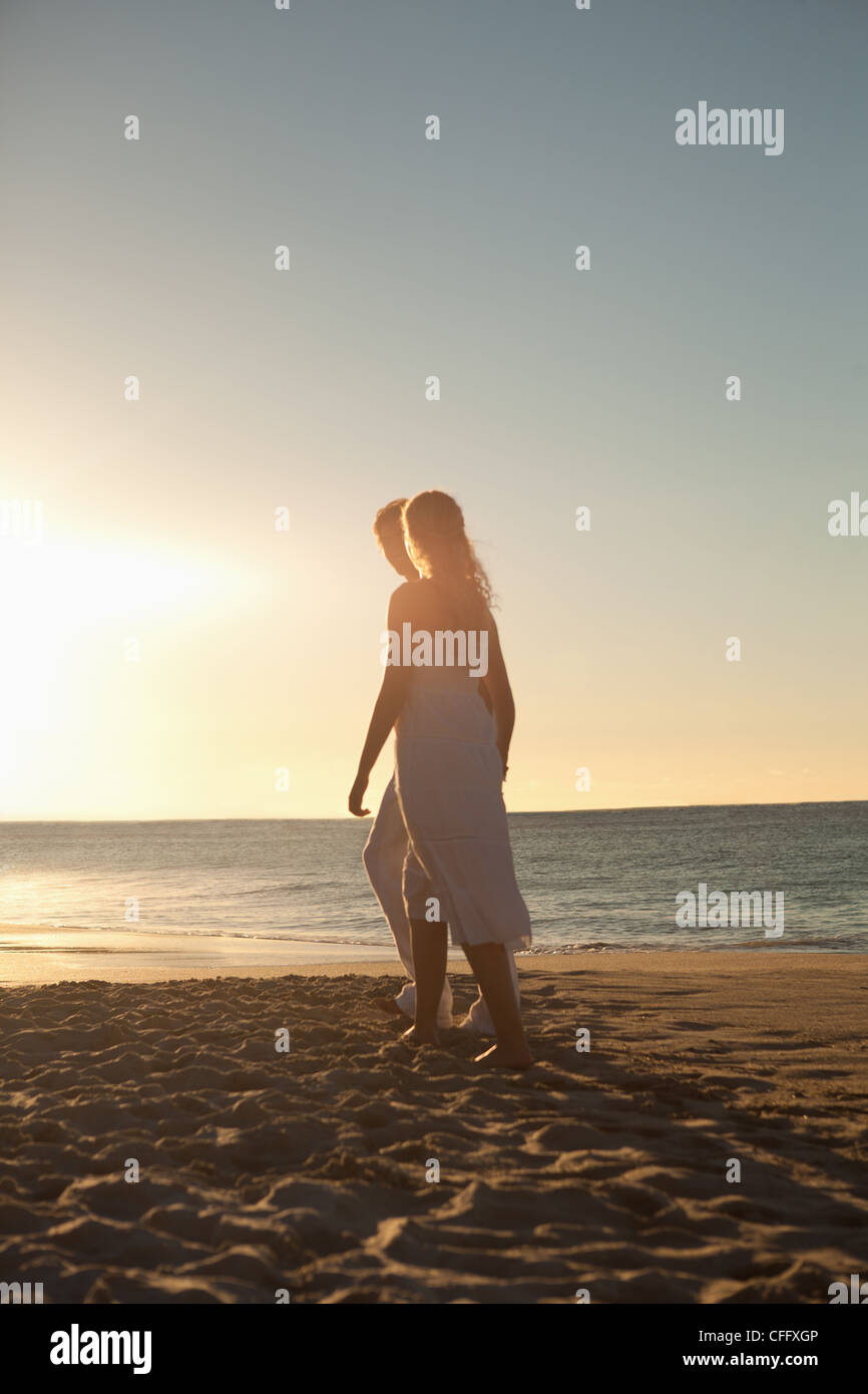 Lovers walking on the beach at the time of sunset Stock Photo Alamy