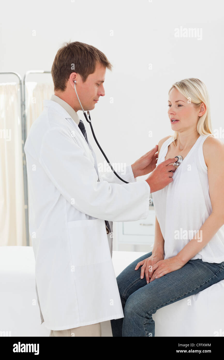 Doctor taking his patients heart beat Stock Photo