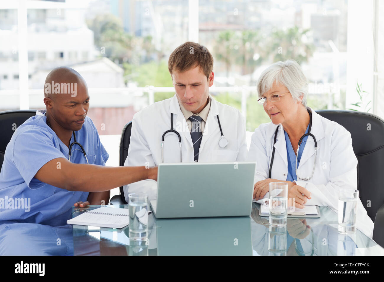 Doctors working on laptop Stock Photo
