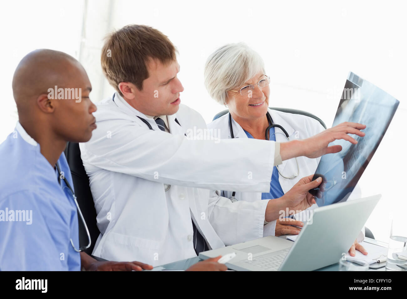 Doctors in meeting room looking at an x-ray Stock Photo