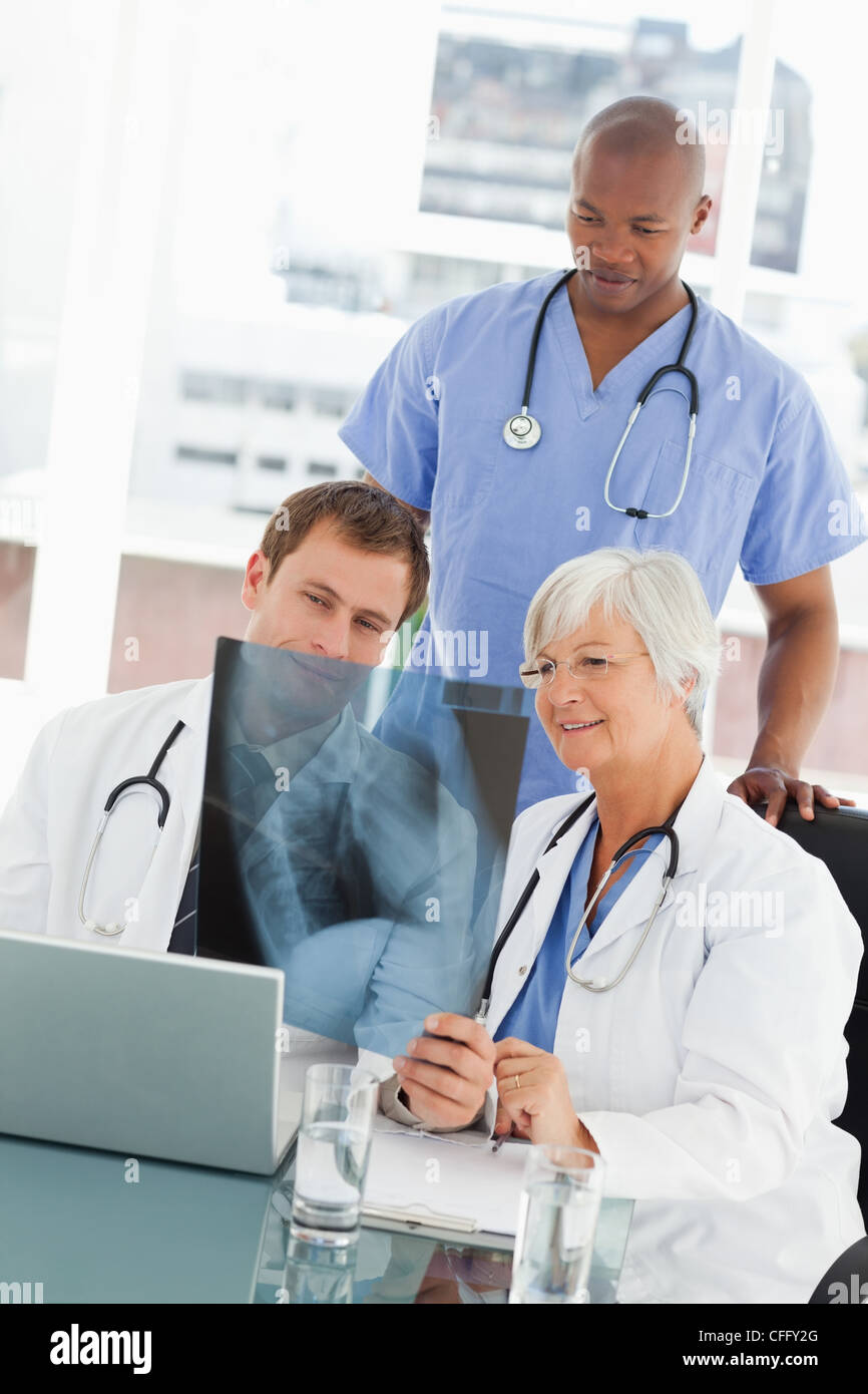 Doctor explaining an x-ray to her colleagues Stock Photo