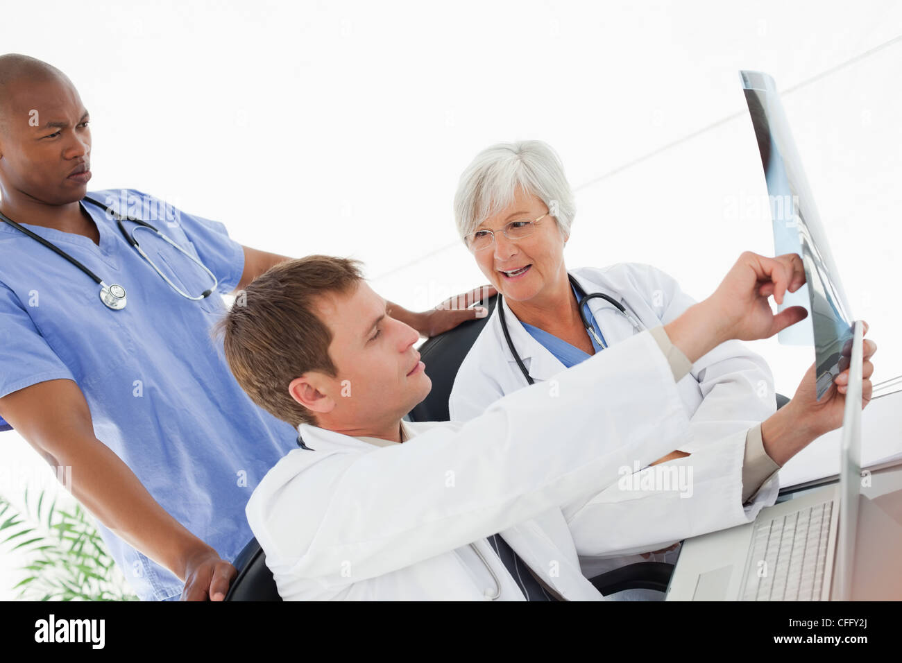 Side view of doctors talking about an x-ray Stock Photo