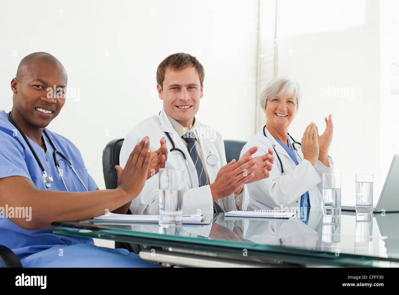 Smiling doctors applauding Stock Photo