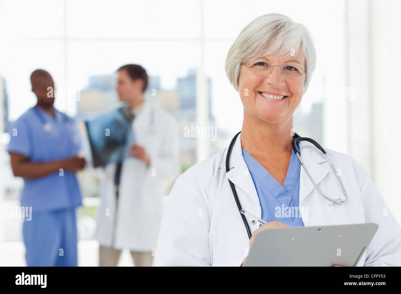 Happy smiling mature doctor hi-res stock photography and images - Alamy
