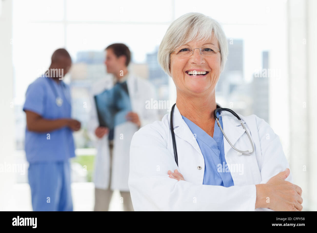 Happy smiling mature doctor hi-res stock photography and images - Alamy