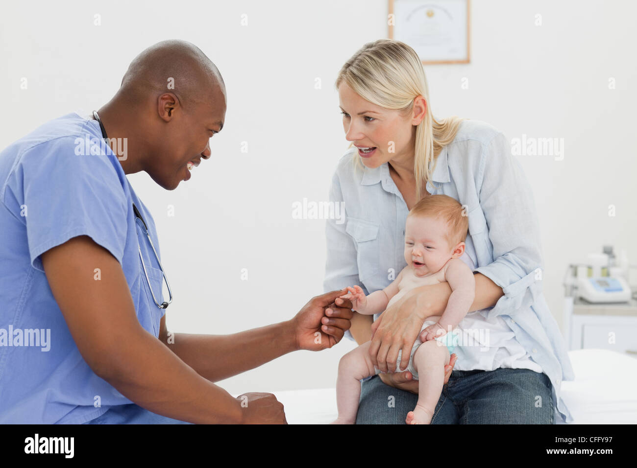 Doctor taking his little patients hand Stock Photo