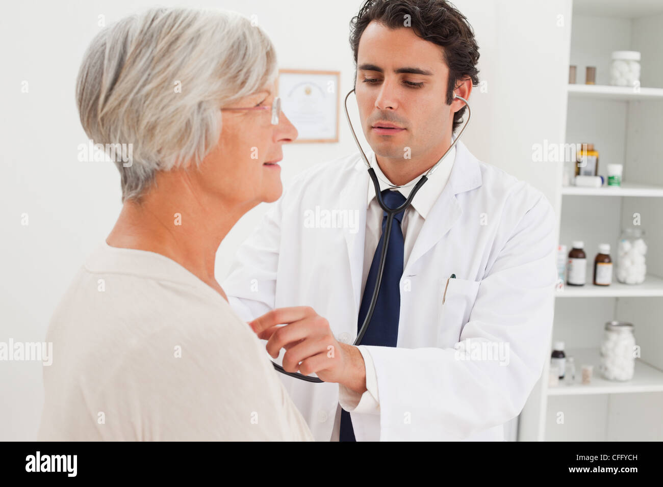 Doctor taking mature patients heart beat Stock Photo