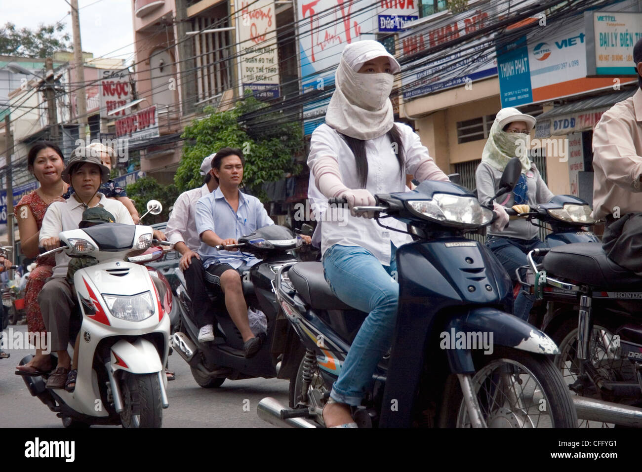 People are driving motorcycles in heavy traffic on a busy and crowded street in Saigon (Ho Chi Minh City) Vietnam. Stock Photo