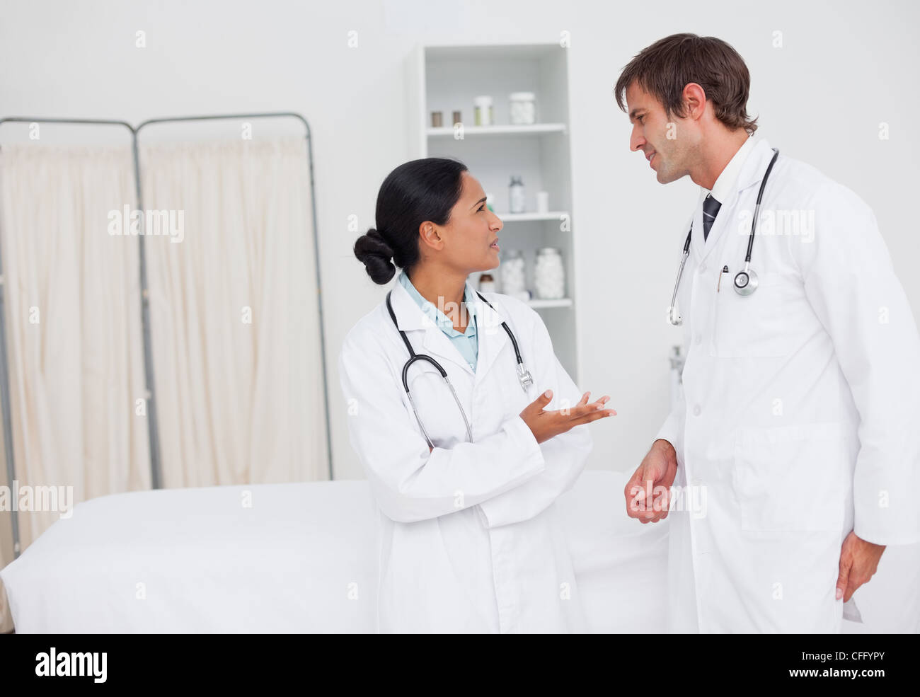 Young surgeons talking to each other in a hospital room Stock Photo