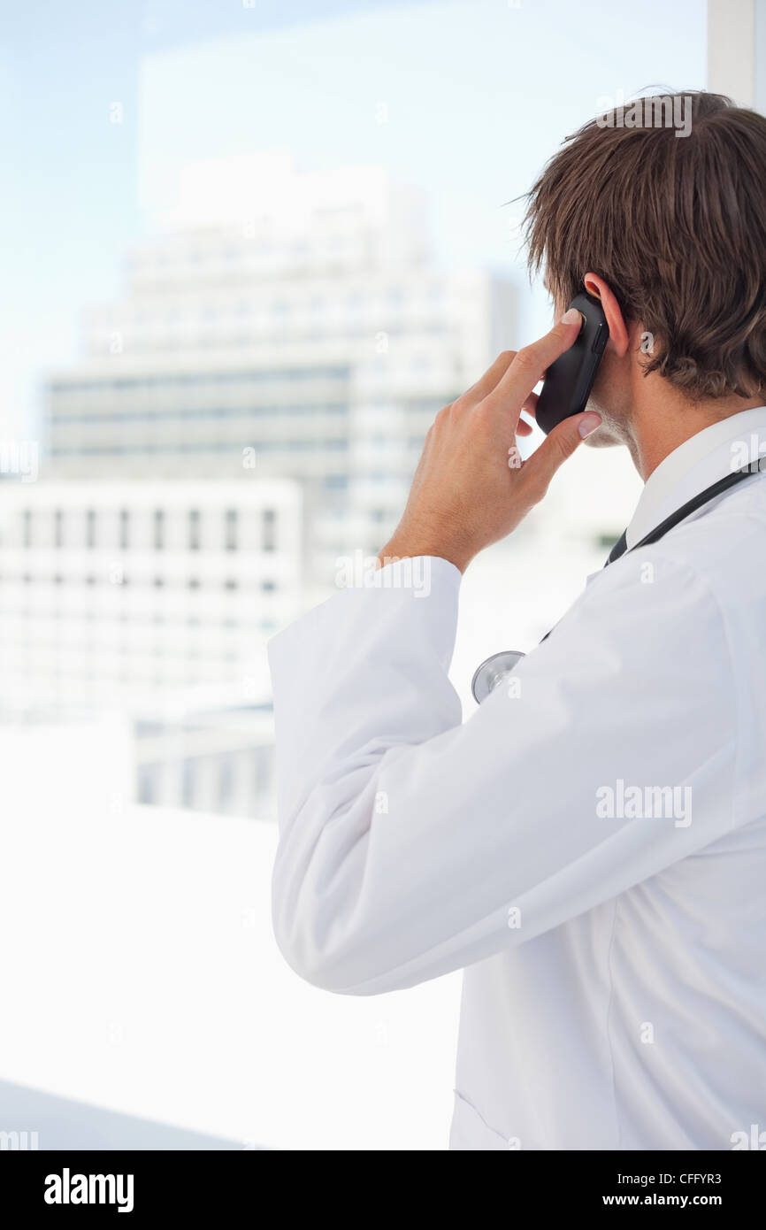 Rear view of a young doctor talking on the phone Stock Photo
