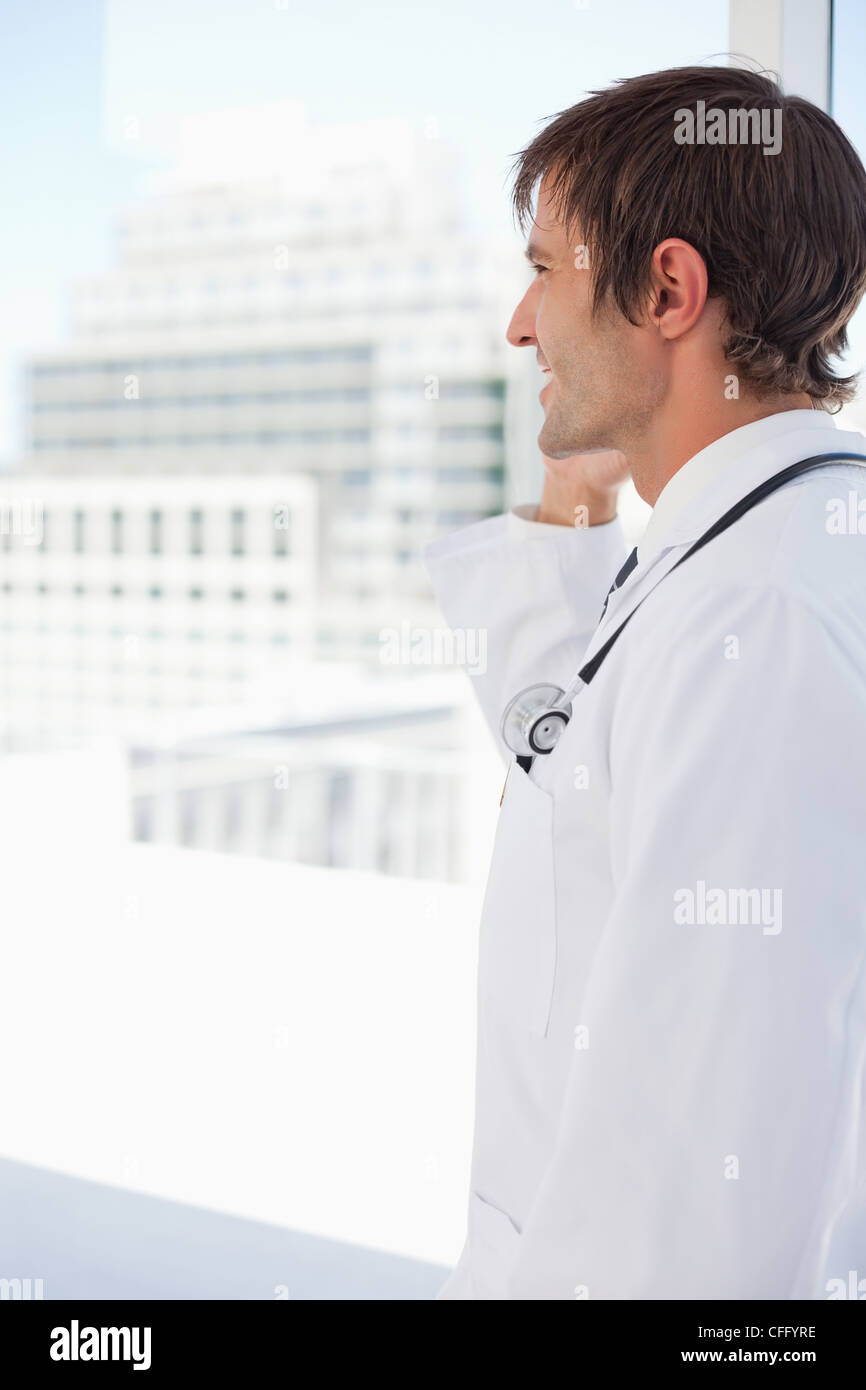 Side view of a happy doctor talking on the phone Stock Photo