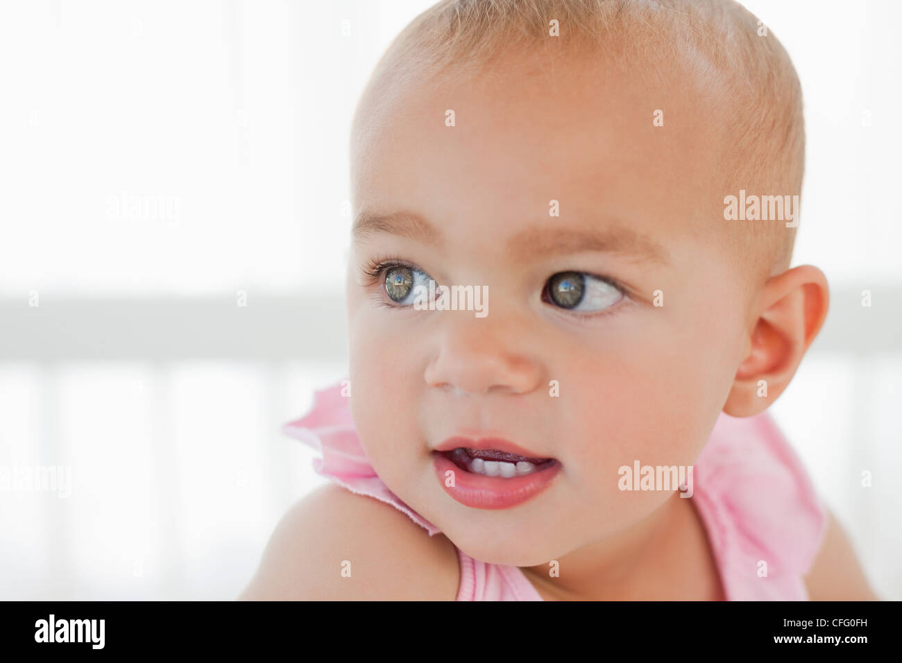 Surprised baby turning her head back Stock Photo