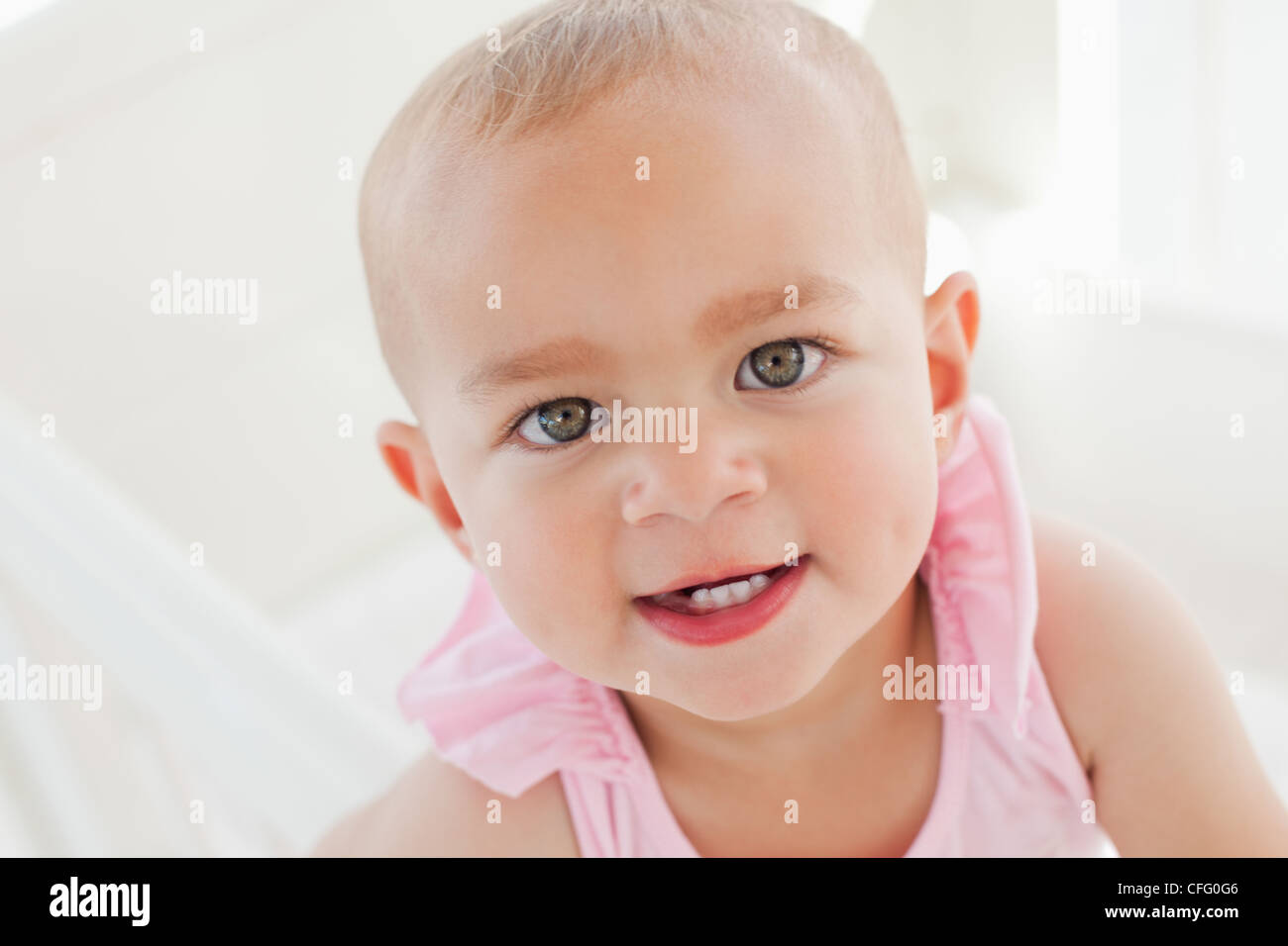 Lovely baby looking at the camera while opening her mouth Stock Photo