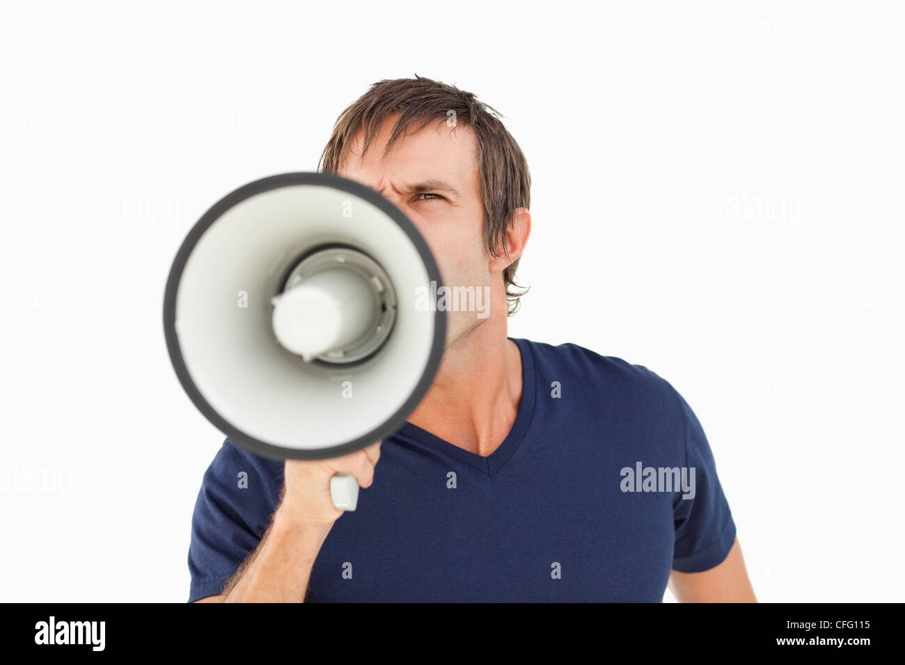 Furious man holding a megaphone while standing up Stock Photo