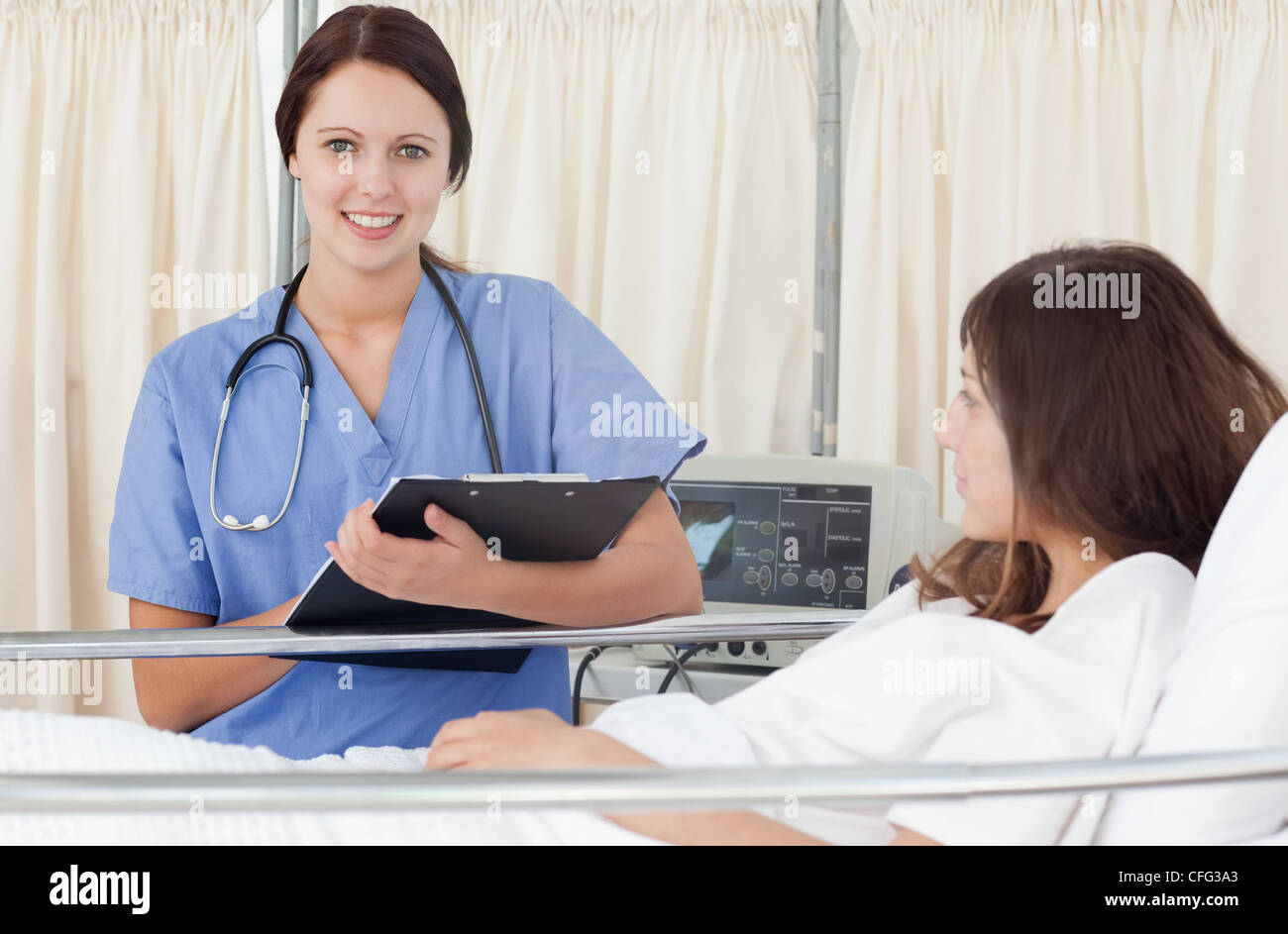 Smiling nurse standing next hi-res stock photography and images - Alamy