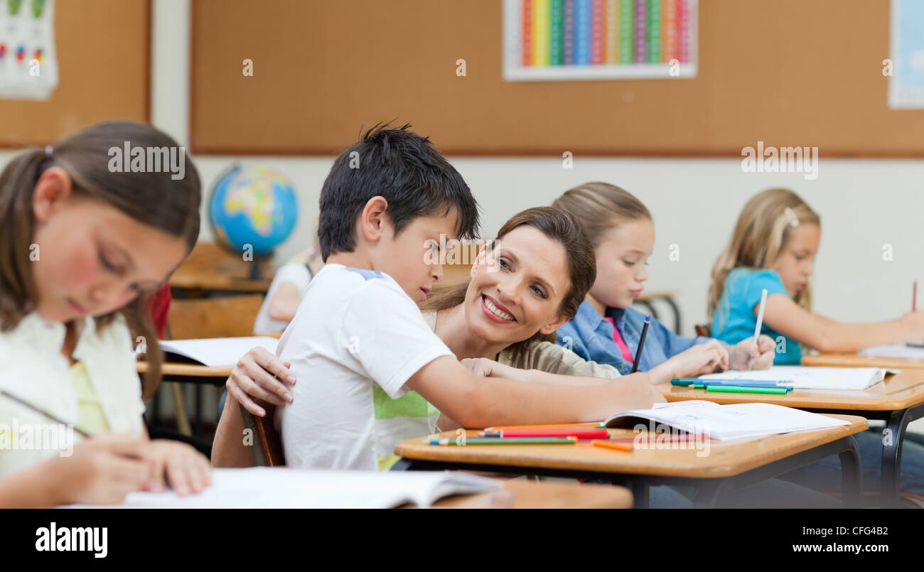 Side view of teacher helping student Stock Photo