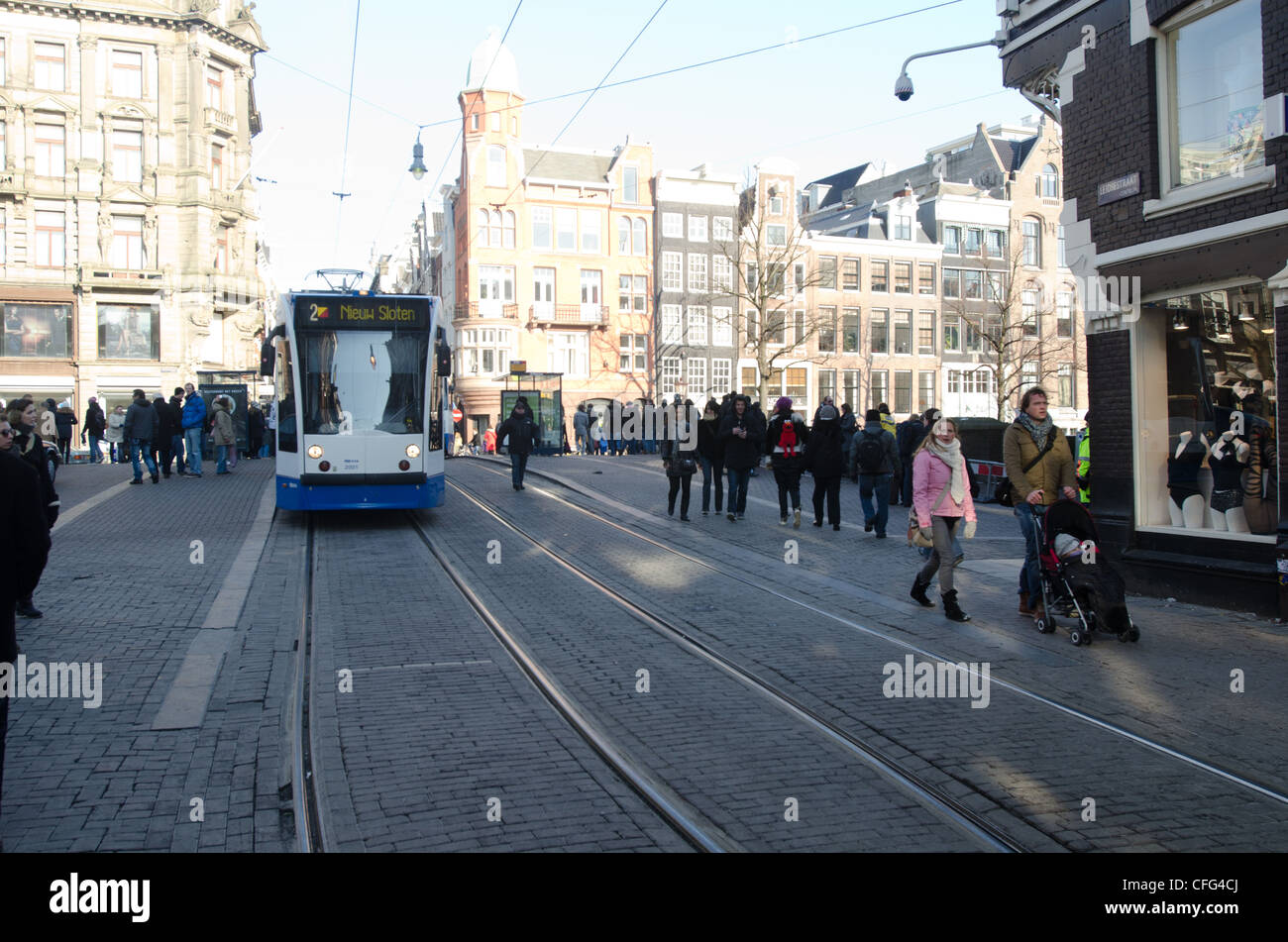 Street of Amsterdam, with tram traveling Stock Photo
