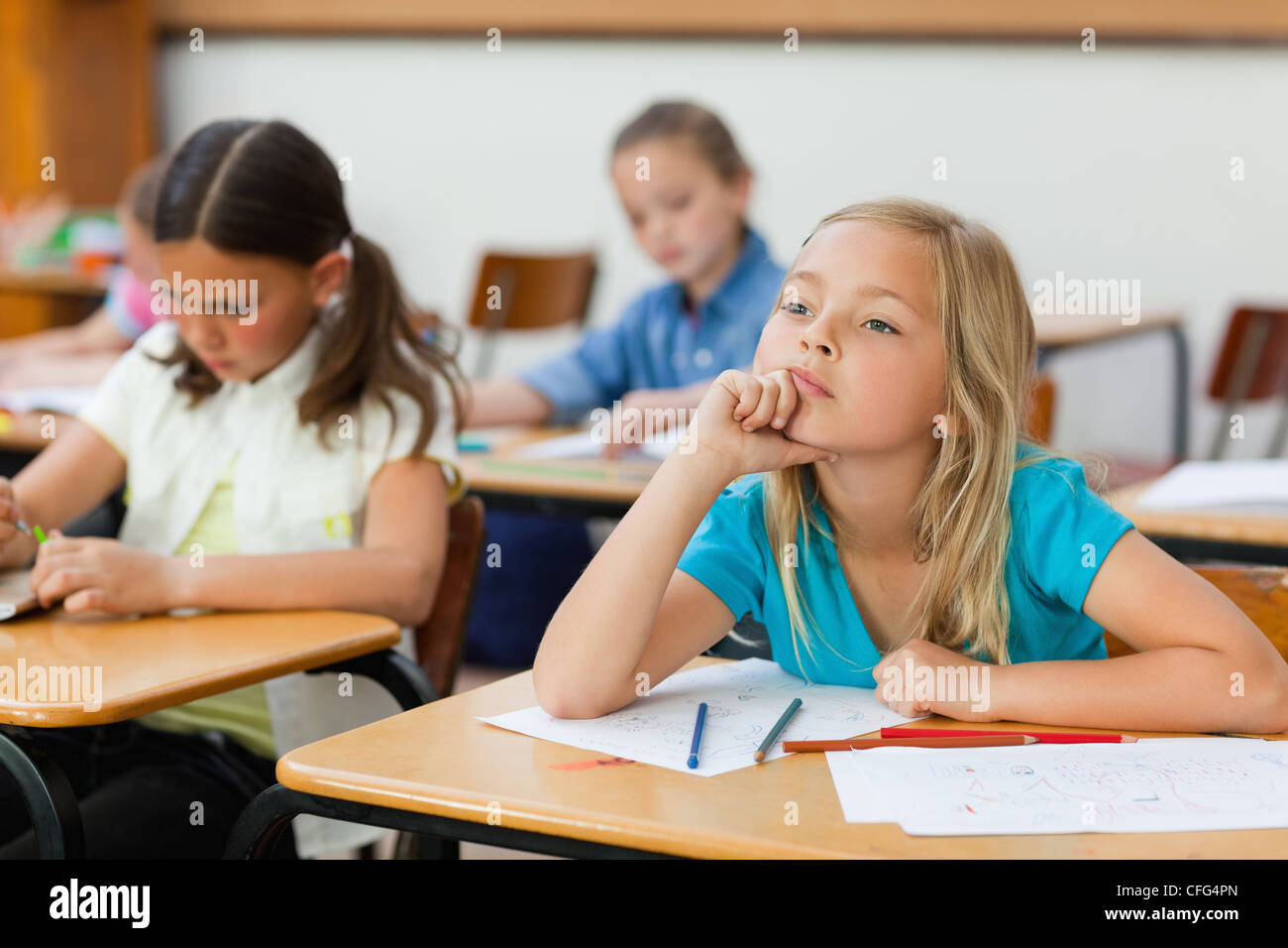 Girl in class doesn't seem very focused Stock Photo
