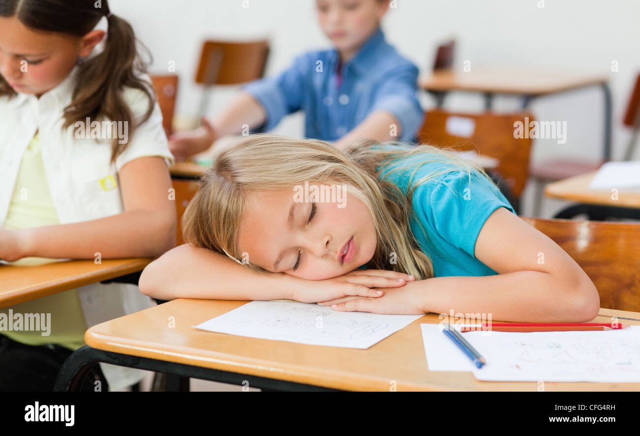 Girl snoozing in class Stock Photo