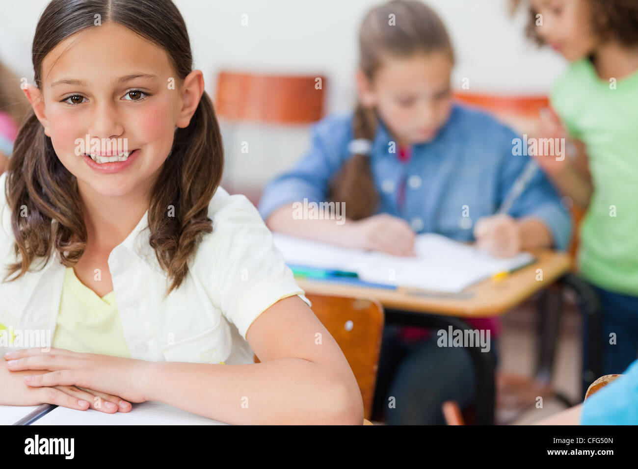 Smiling girl attending class Stock Photo