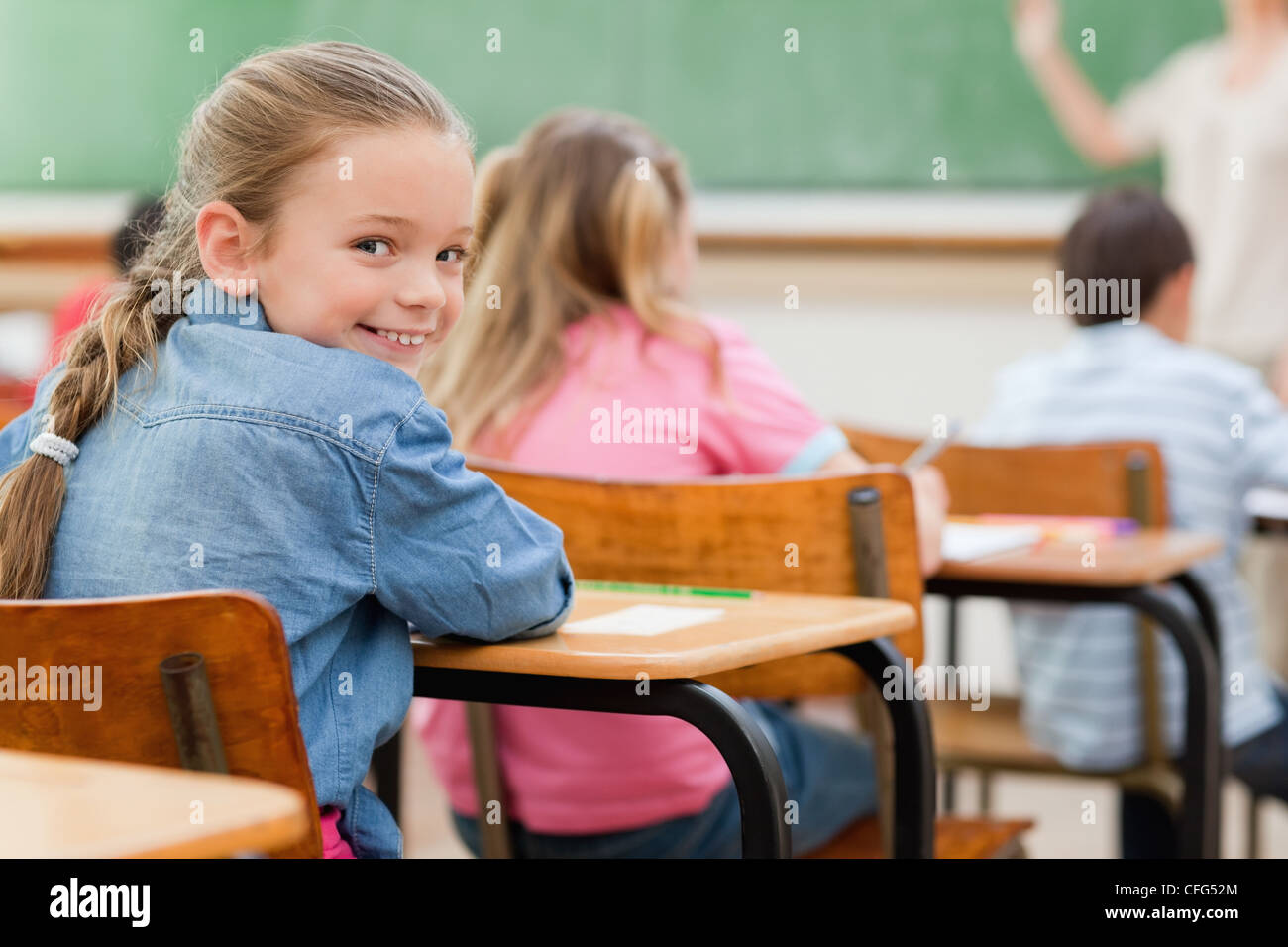 Primary student turning around in class Stock Photo