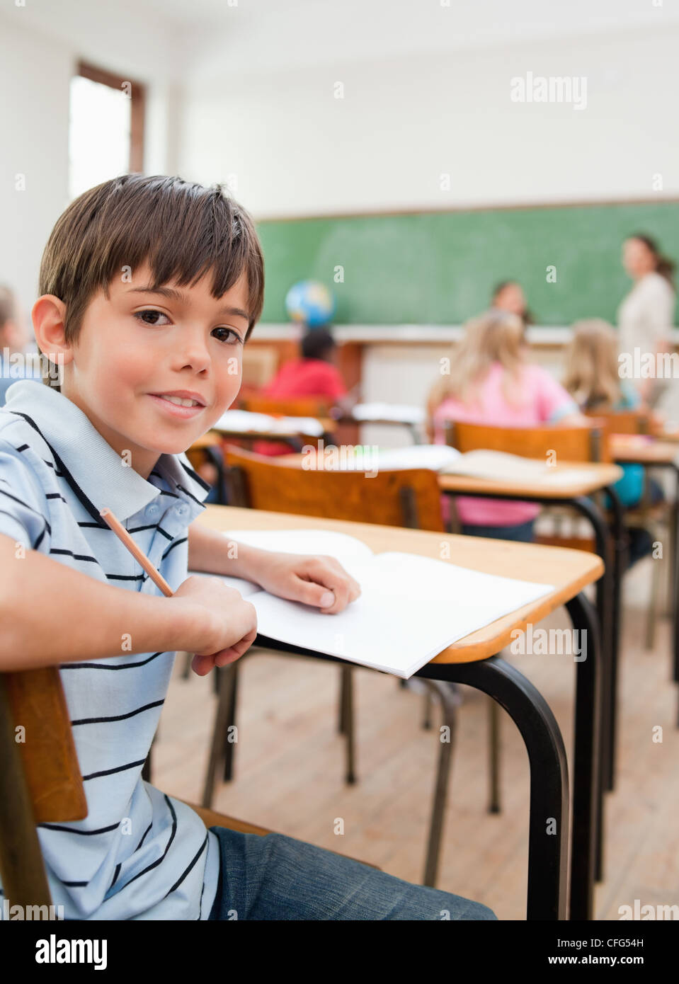 Schoolboy turned around in class Stock Photo