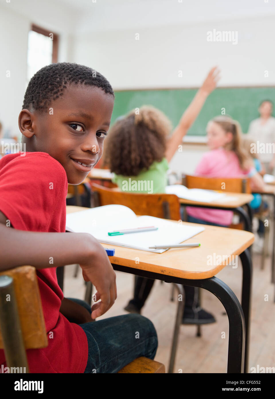 Smiling student turned around in class Stock Photo