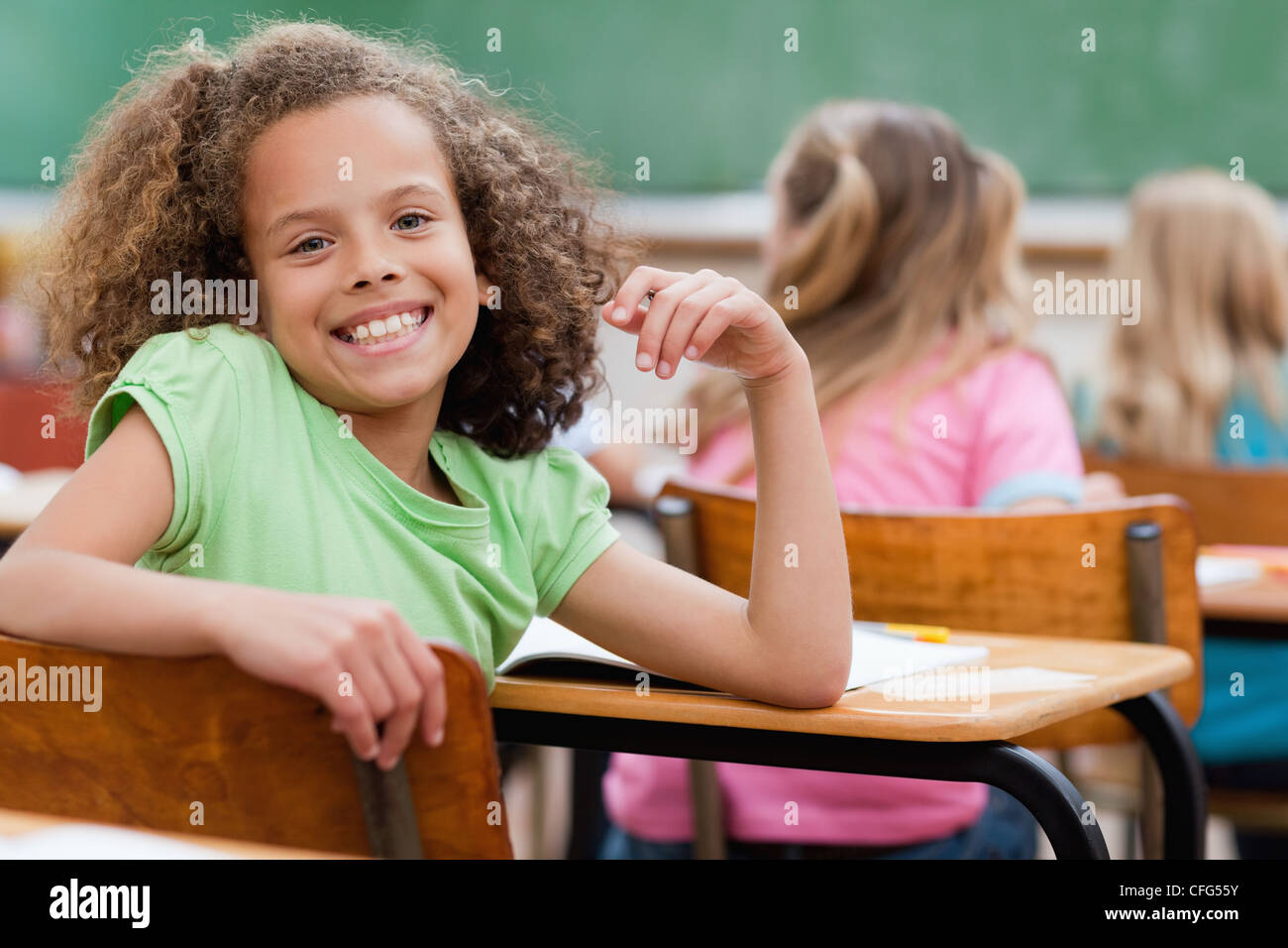 Happy girl turned around during class Stock Photo