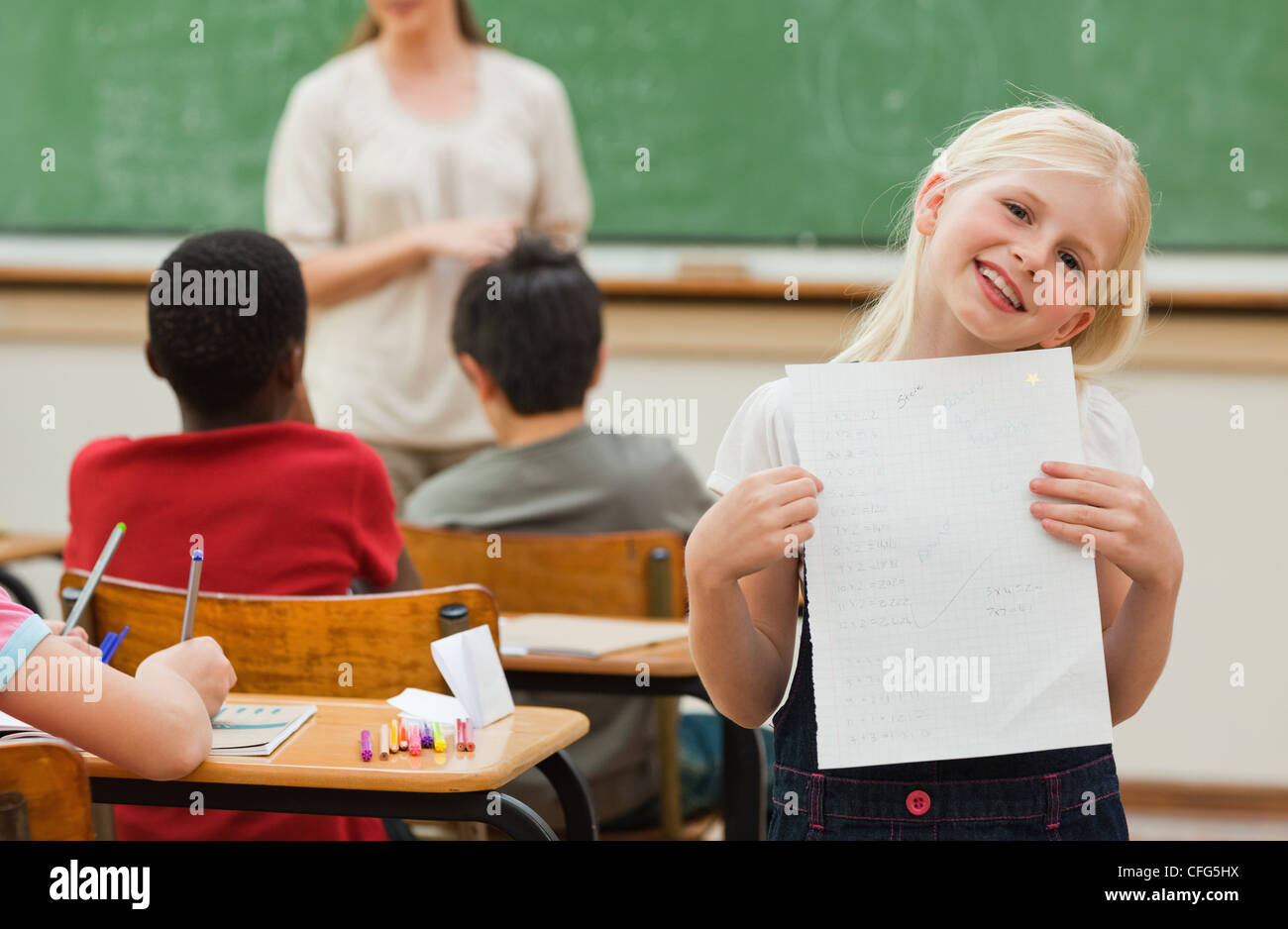 Smiling girl showing test results Stock Photo