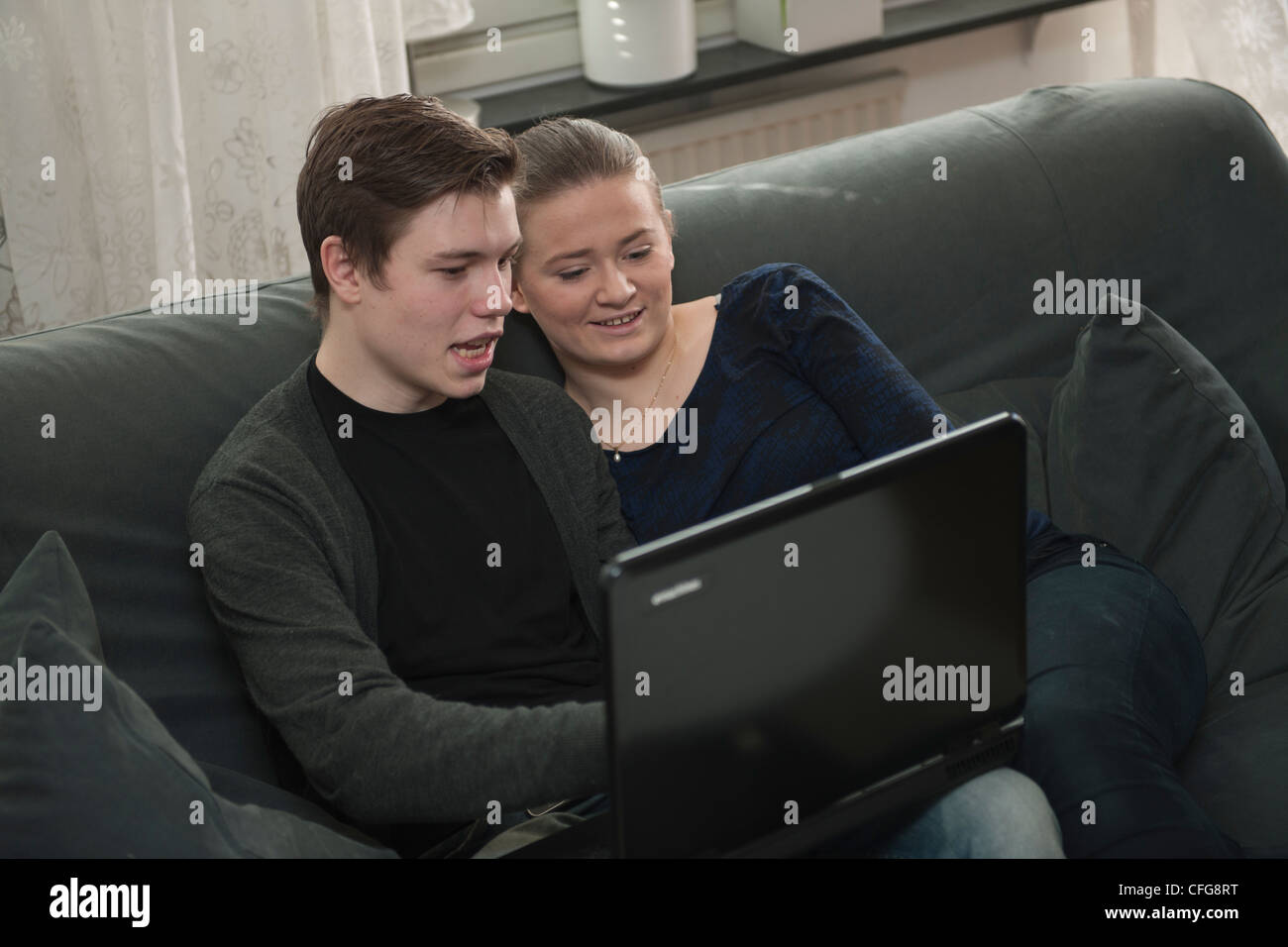 Young couple with a laptop Stock Photo - Alamy