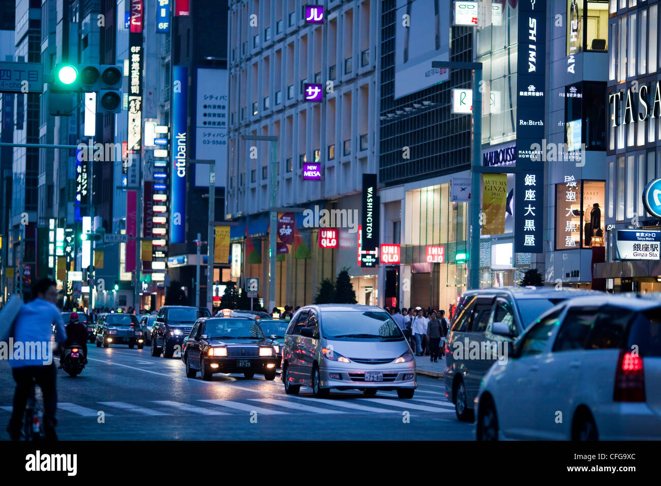 Street traffic and neon lights at night in the Ginza district of Tokyo,Japan Stock Photo