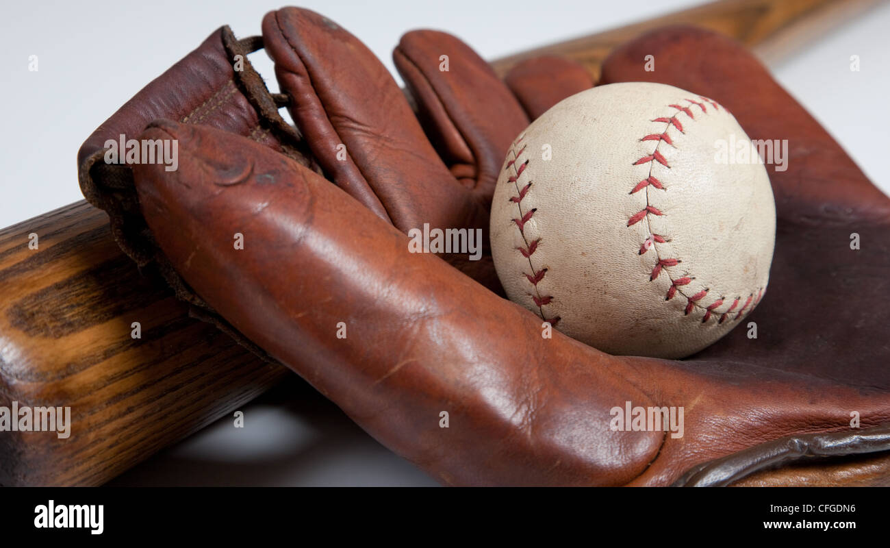 An antique baseball bat, mitt and ball on a white background Stock