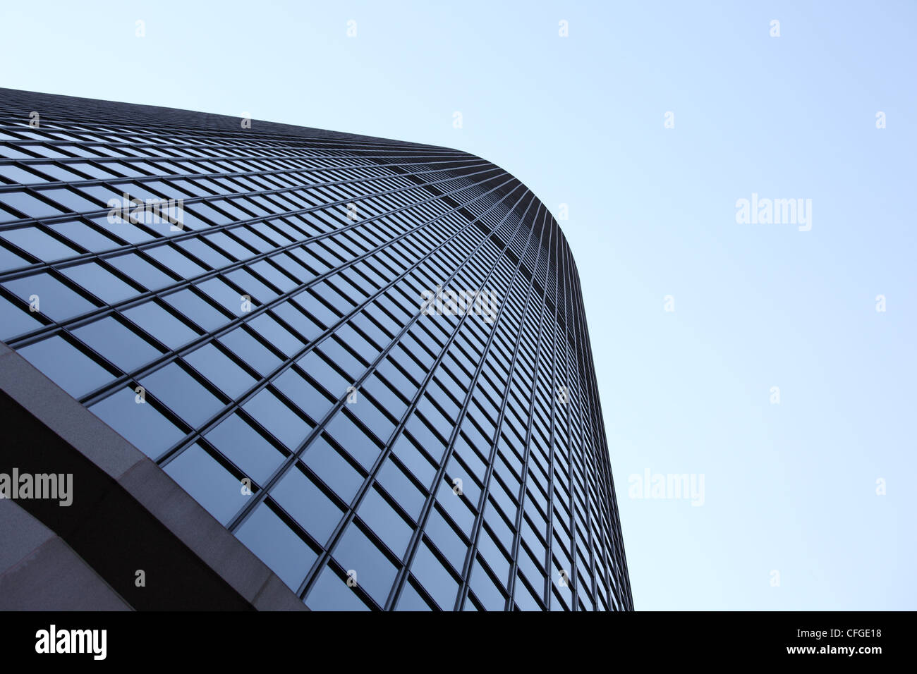 A tall windowed skyscraper with sky background Stock Photo