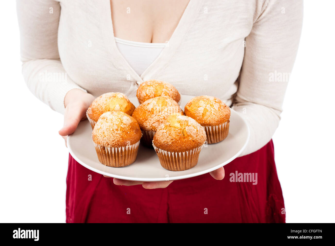 Detail of woman holding plate with fresh muffins, isolated on white background. Stock Photo
