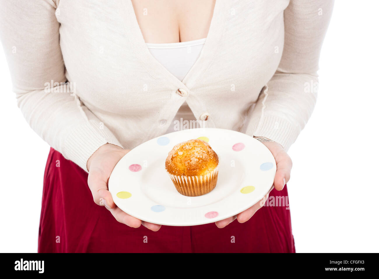 Detail of woman holding plate with fresh muffin, isolated on white background. Stock Photo